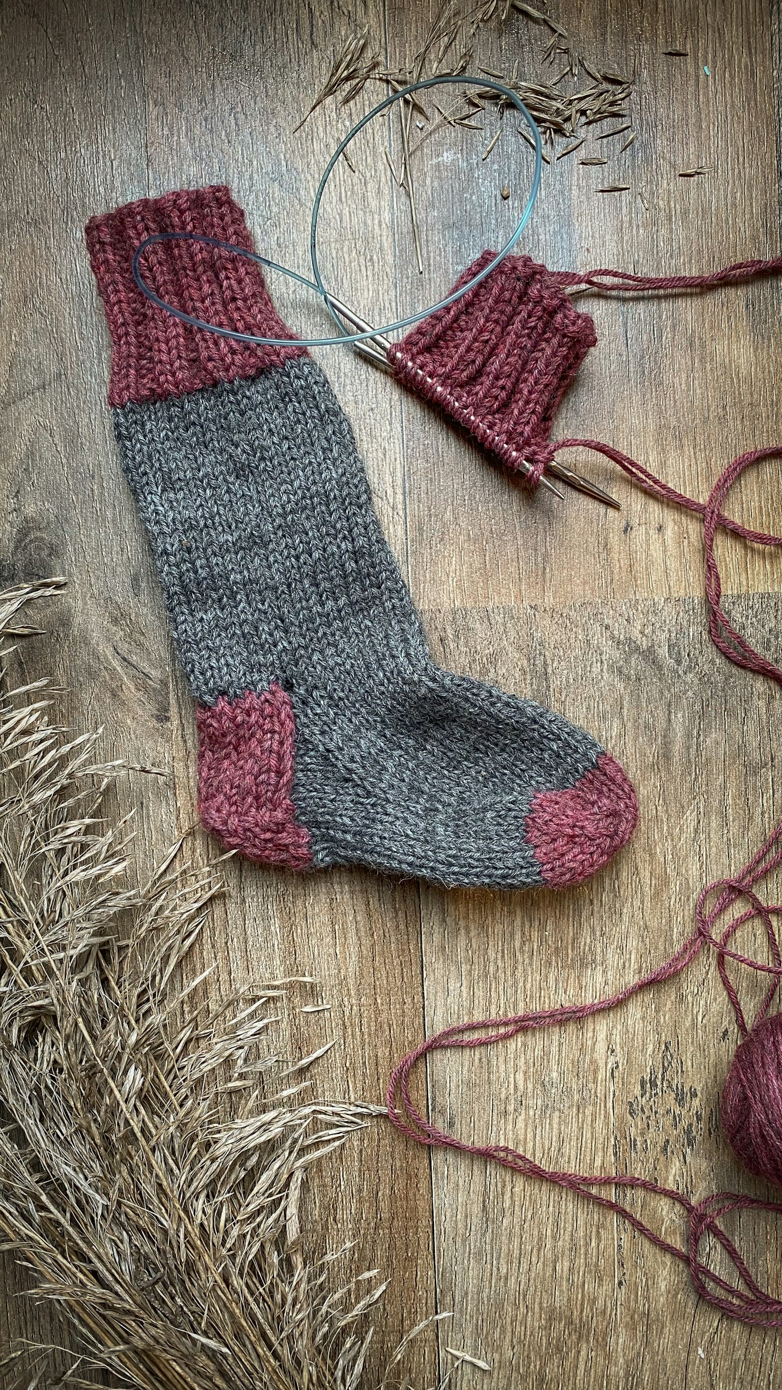 Knitted wool socks on a wooden floor