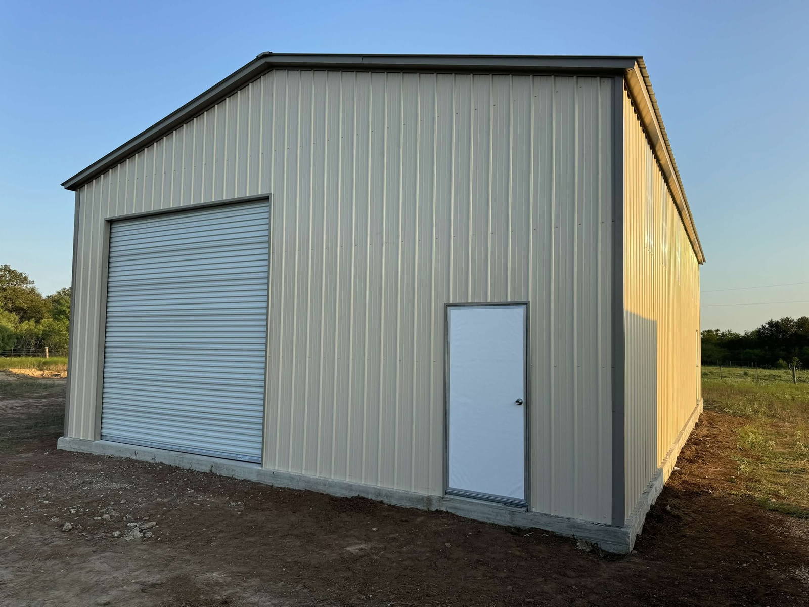 30x50x14 tan metal garage with roll-up door and walk-in door