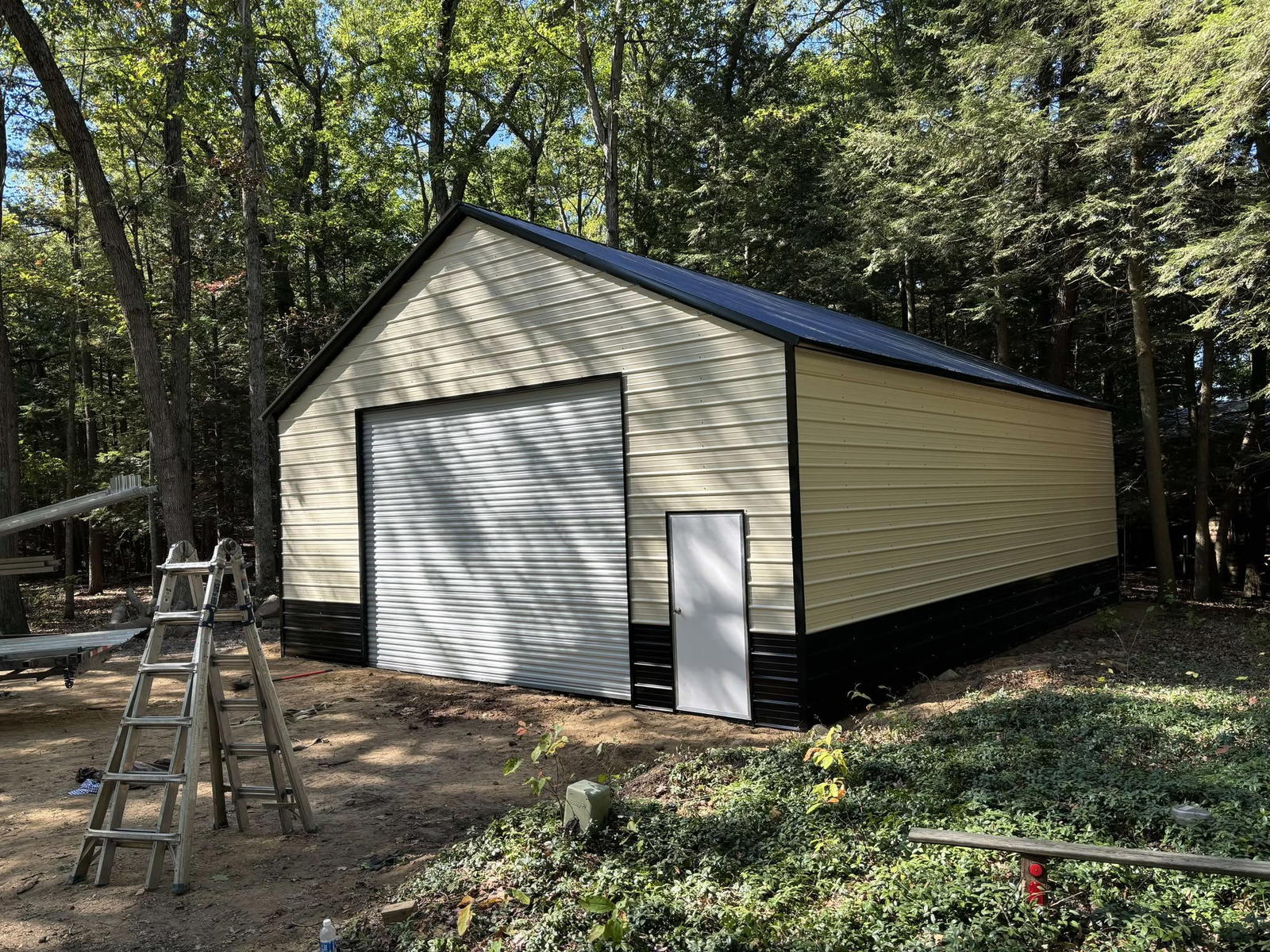 30x40x12 metal garage with cream walls and black wainscot installed by Pinnacle Metal Buildings