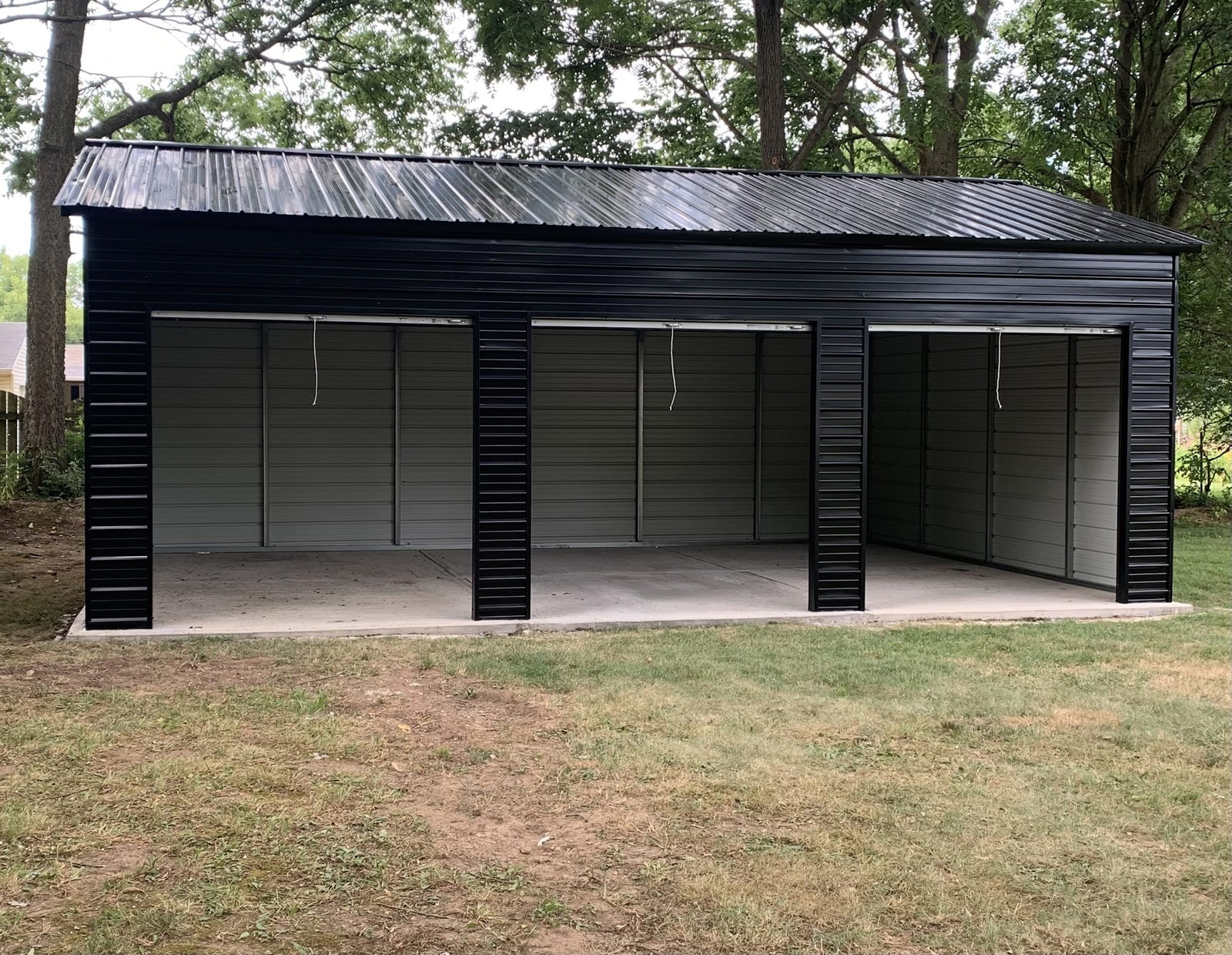 20x30x10 three-bay metal garage with gray walls and black trim